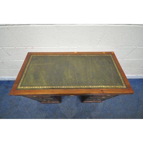 1283 - A 20TH CENTURY MAHOGANY KNEEHOLE DESK, with a green leather writing surface, fitted with nine assort... 