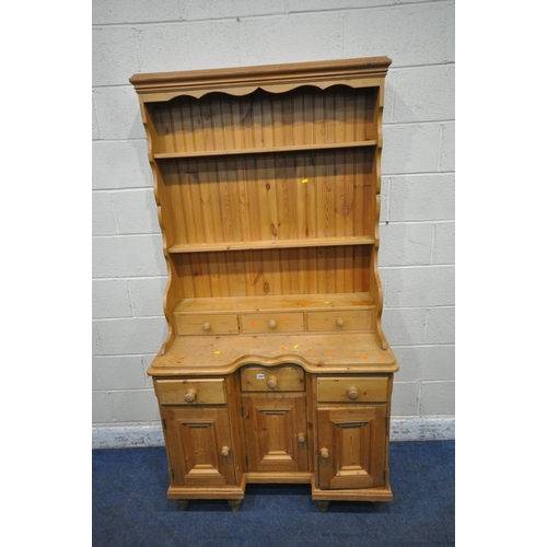 1284 - A 20TH CENTURY PINE DRESSER, the three tier plate rack with three drawers, atop a base with three dr... 