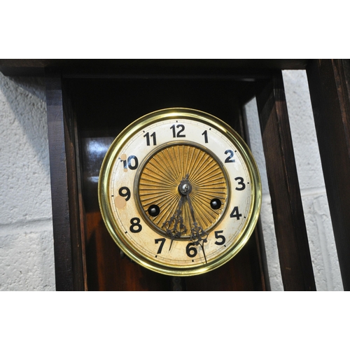 1291 - A 20TH CENTURY WALNUT WALL CLOCK, the glazed door enclosing a 6 inch enamel dial, depicting Arabic n... 