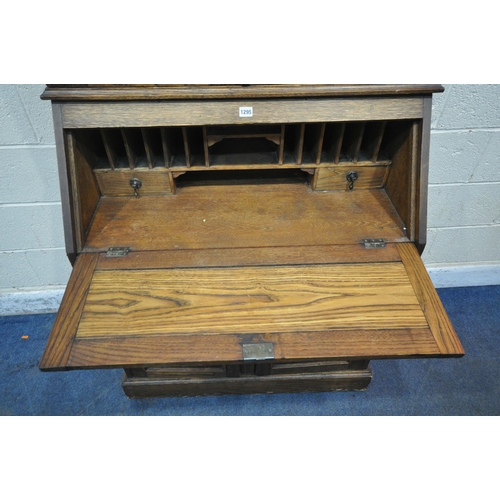 1295 - A 20TH CENTURY OAK BUREAU BOOKCASE, fitted with double lead glazed doors, atop a base with a fall fr... 