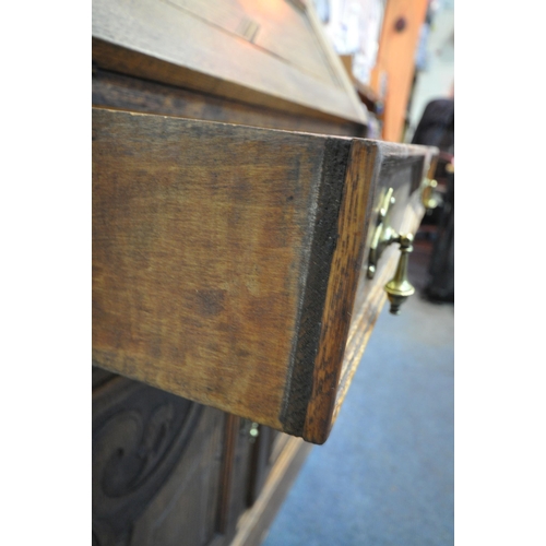 1295 - A 20TH CENTURY OAK BUREAU BOOKCASE, fitted with double lead glazed doors, atop a base with a fall fr... 