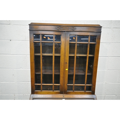 1296 - A 20TH CENTURY OAK BUREAU BOOKCASE, with double glazed doors, atop a base with a fall front door, ab... 