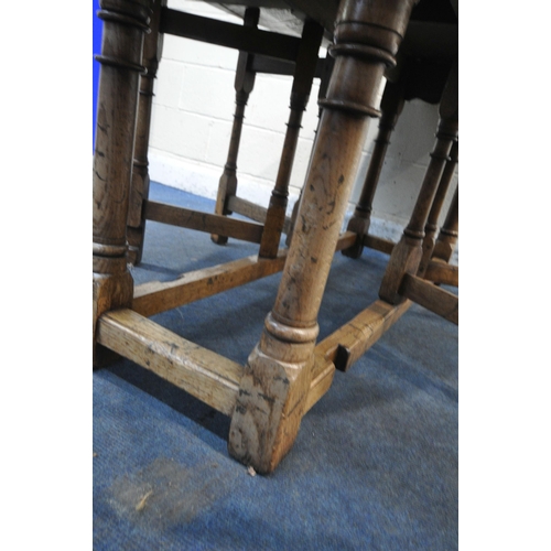 1298 - AN 18TH CENTURY STYLE OAK WAKE TABLE, raised on block and turned legs, open width 143cm x closed wid... 