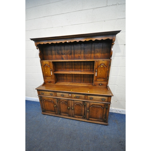 1299 - IN THE MANNER OF TITCHMARSH AND GOODWIN, AN 18TH CENTURY STYLE SOLID OAK DRESSER, the three tier pla... 