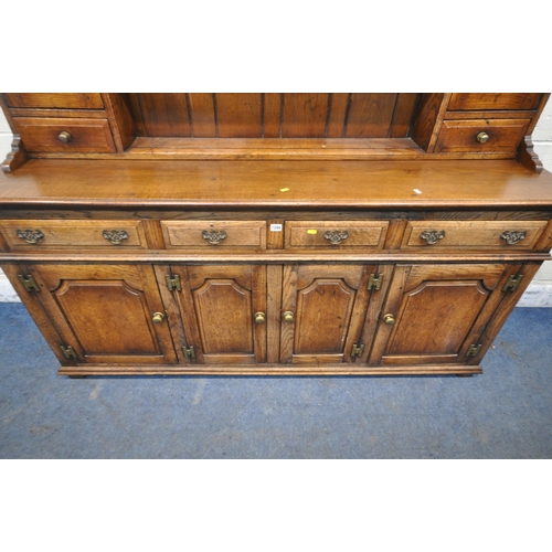 1299 - IN THE MANNER OF TITCHMARSH AND GOODWIN, AN 18TH CENTURY STYLE SOLID OAK DRESSER, the three tier pla... 