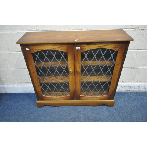 1300 - A LATE 20TH CENTURY OAK BOOKCASE, with double lead glazed doors, width 93cm x depth 26cm x height 85... 