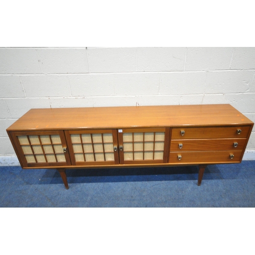 1311 - HERBERT GIBBS FOR YOUNGER, A MID CENTURY TEAK SIDEBOARD, fitted with three cupboard doors, and three... 