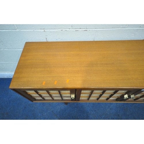 1311 - HERBERT GIBBS FOR YOUNGER, A MID CENTURY TEAK SIDEBOARD, fitted with three cupboard doors, and three... 