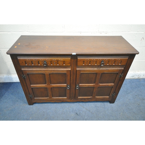 1325 - A 20TH CENTURY OAK SIDEBOARD, with two drawers, above double cupboard doors, width 125cm x depth 44c... 