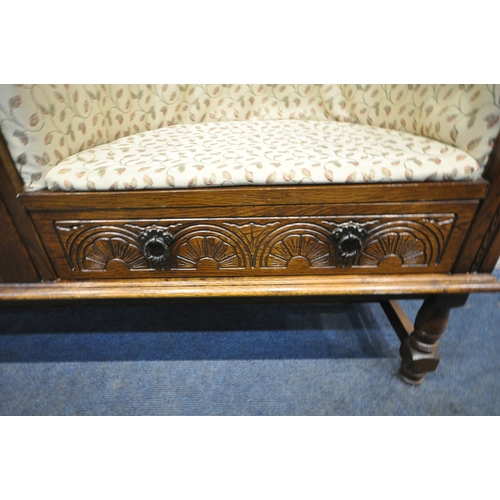 1328 - A LATE 20TH CENTURY OAK TELEPHONE SEAT, with foliate upholstery, a single linenfold door, and a sing... 