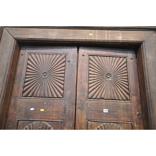 1330 - A HEAVY CARVED EASTERN HARDWOOD DOUBLE DOORS, within a moulded frame, the doors with reeded rosette ... 