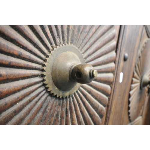 1330 - A HEAVY CARVED EASTERN HARDWOOD DOUBLE DOORS, within a moulded frame, the doors with reeded rosette ... 