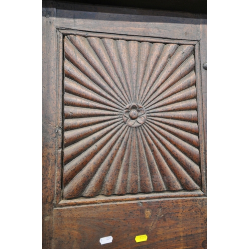 1330 - A HEAVY CARVED EASTERN HARDWOOD DOUBLE DOORS, within a moulded frame, the doors with reeded rosette ... 