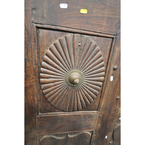 1330 - A HEAVY CARVED EASTERN HARDWOOD DOUBLE DOORS, within a moulded frame, the doors with reeded rosette ... 