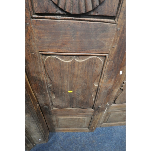 1330 - A HEAVY CARVED EASTERN HARDWOOD DOUBLE DOORS, within a moulded frame, the doors with reeded rosette ... 