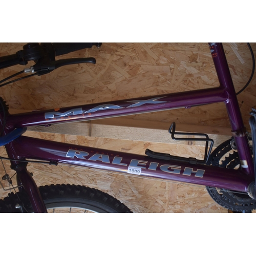 1009 - A RALEIGH MAX OGRE-15 PURPLE BIKE, with a 19 inch frame 15 speed SIS twist grip gears and a Bell hel... 