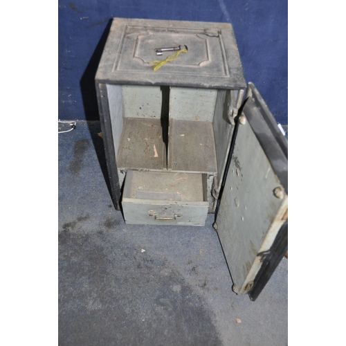 1077 - AN EARLY 20th CENTURY CAST IRON SAFE with panelled detail to the front, sides and top, enclosing two... 