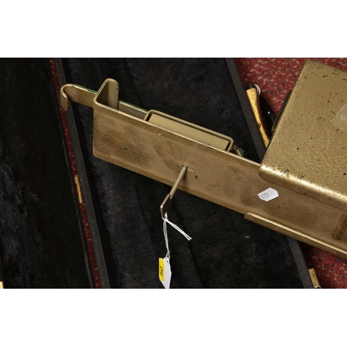 290 - A BLACK EBONISED SHOTGUN CASE AND A GUNMATE GUN KEEP, with brass banding and a furry padded interior... 