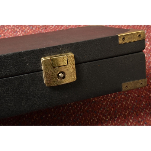 290 - A BLACK EBONISED SHOTGUN CASE AND A GUNMATE GUN KEEP, with brass banding and a furry padded interior... 