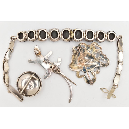 28 - FOUR WHITE METAL ITEMS, to include a white metal and butterfly wing brooch, a salamander style brooc... 