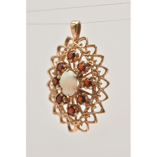 33 - A 9CT GOLD OPAL AND GARNET SET PENDANT, of a lozenge open work shape, set with a central oval cut op... 