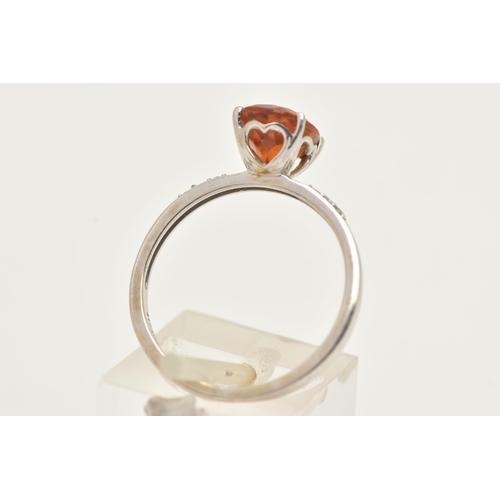 35 - A 9CT WHITE GOLD GEM SET RING, set with a central oval cut Citrine, four claw set in a raised mount,... 