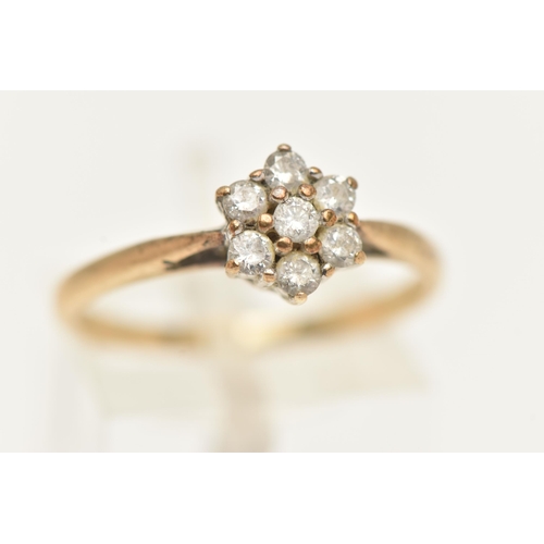 42 - A 9CT GOLD DIAMOND CLUSTER RING, flower shape cluster set with seven round brilliant cut diamonds, i... 