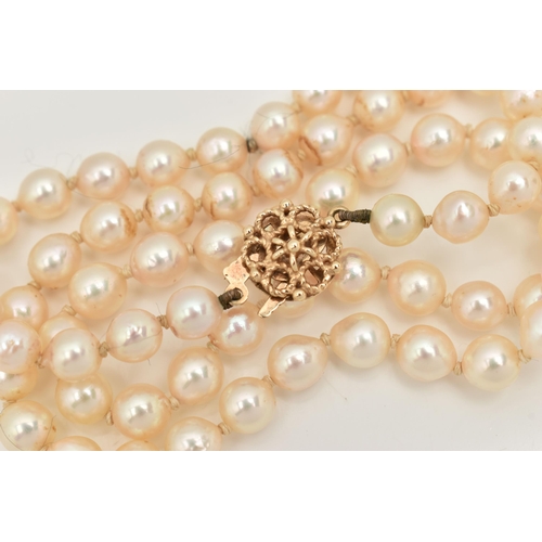 45 - A SINGLE STRAND OF CULTURED PEARLS, row of cream pearls with pink hues, individually knotted on a wh... 