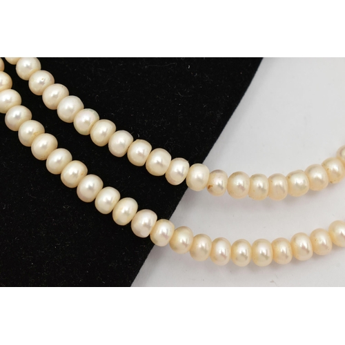 63 - A CULTURED FRESH WATER PEARL NECKLACE, a single strand necklace, fitted with a yellow metal clasp, a... 