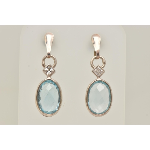 68 - A PAIR OF TOPAZ EARRINGS, faceted oval topaz stones collet set with square cut cubic zirconia accent... 