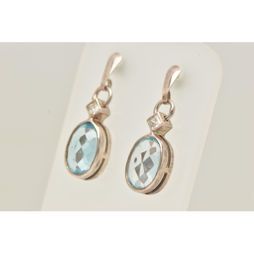 68 - A PAIR OF TOPAZ EARRINGS, faceted oval topaz stones collet set with square cut cubic zirconia accent... 