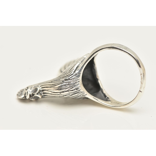 70 - A LARGE WHITE METAL RING, designed as a chicken, leading on to a tapered shank, approximate height 2... 