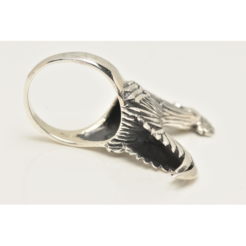 70 - A LARGE WHITE METAL RING, designed as a chicken, leading on to a tapered shank, approximate height 2... 