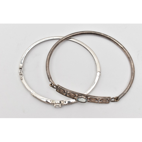 76 - TWO WHITE METAL BANGLES, the first a white metal hinged bangle set with cubic zirconia, the second a... 