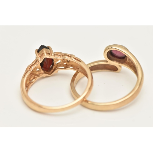 78 - TWO 9CT GOLD GEM SET RINGS, the first set with a marquise cut garnet four claw set to the Celtic pat... 