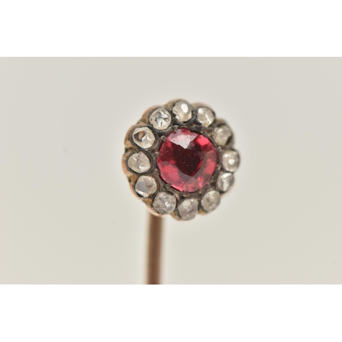 80 - A YELLOW METAL CLUSTER STICK PIN, of a circular form set to the centre with a garnet topped red past... 