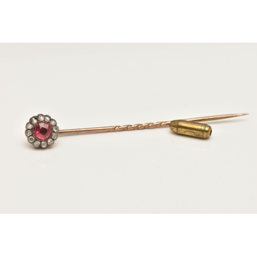 80 - A YELLOW METAL CLUSTER STICK PIN, of a circular form set to the centre with a garnet topped red past... 