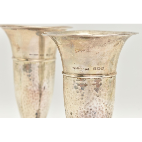 96 - A PAIR OF EARLY 20TH CENTURY SILVER POSY VASES, tapering form with hammer effect, on round weighted ... 