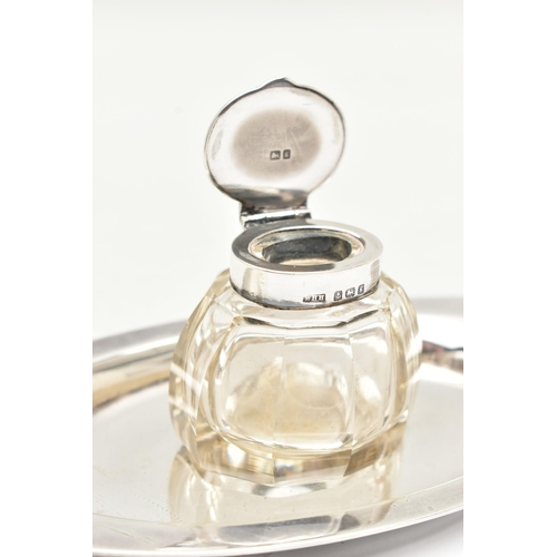 98 - AN EDWARD VII INKWELL, a small glass inkwell with a plain polished hinged silver lid, together with ... 