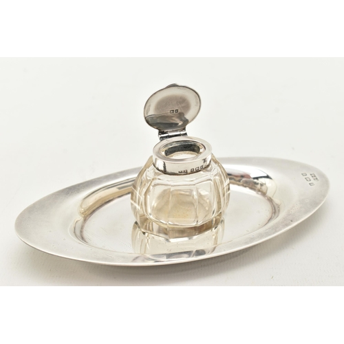 98 - AN EDWARD VII INKWELL, a small glass inkwell with a plain polished hinged silver lid, together with ... 