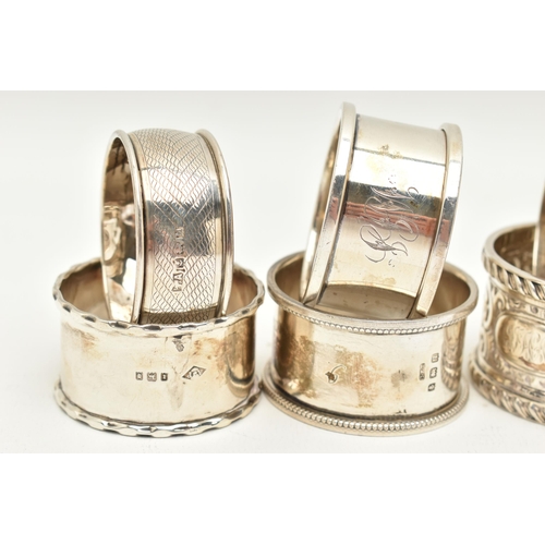 99 - AN ASSORTMENT OF SILVER NAPKIN RINGS, eight silver napkins all with varying designs, four hallmarked... 