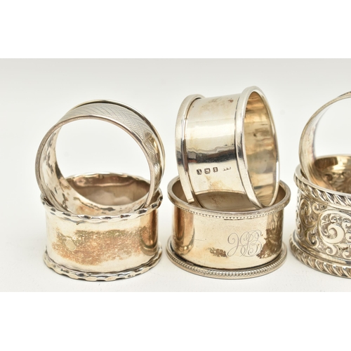 99 - AN ASSORTMENT OF SILVER NAPKIN RINGS, eight silver napkins all with varying designs, four hallmarked... 