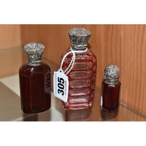 305 - THREE VICTORIAN CRANBERRY GLASS SCENT BOTTLES, comprising two cut cranberry glass bottles with flora... 