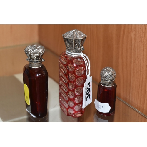 305 - THREE VICTORIAN CRANBERRY GLASS SCENT BOTTLES, comprising two cut cranberry glass bottles with flora... 