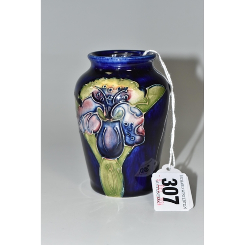 307 - A BLUE MOORCROFT 'ORCHID' VASE with a tube lined orchid pattern on a cobalt blue ground, height 10cm... 