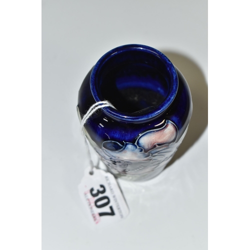 307 - A BLUE MOORCROFT 'ORCHID' VASE with a tube lined orchid pattern on a cobalt blue ground, height 10cm... 