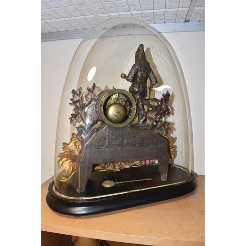 315 - A GLASS DOMED METAL MANTEL CLOCK comprising a gilded and bronzed metal figural mantel clock depictin... 