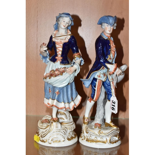 316 - A PAIR OF RUDOLSTADT VOLKSTEDT FIGURINES comprising a  female figurine carrying flowers in her dress... 