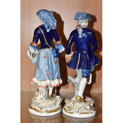 316 - A PAIR OF RUDOLSTADT VOLKSTEDT FIGURINES comprising a  female figurine carrying flowers in her dress... 