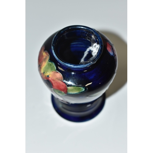 318 - A BLUE MOORCROFT POTTERY 'ORCHID' VASE with a tube lined orchid pattern on a cobalt blue ground, hei... 